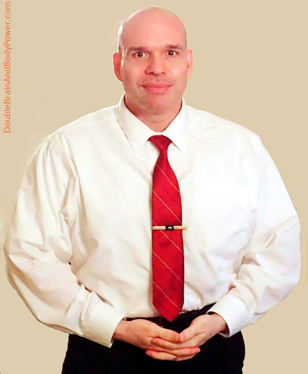 Photo of Mark Cammack wearing a white shirt and red tie