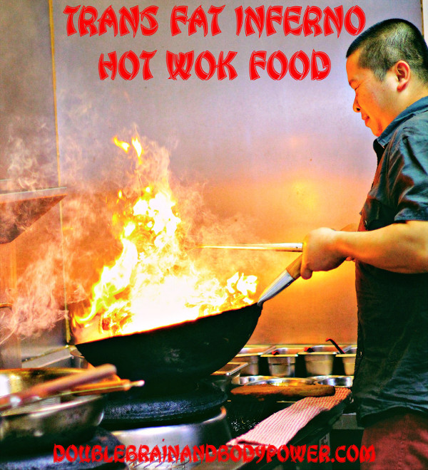 Image of an Asian man cooking with a wok that is on fire with smoke and bright yellow-orange flames. At the top of the photo it say in a large Asian influenced font, Trans Fat Inferno: Hot Wok Food.